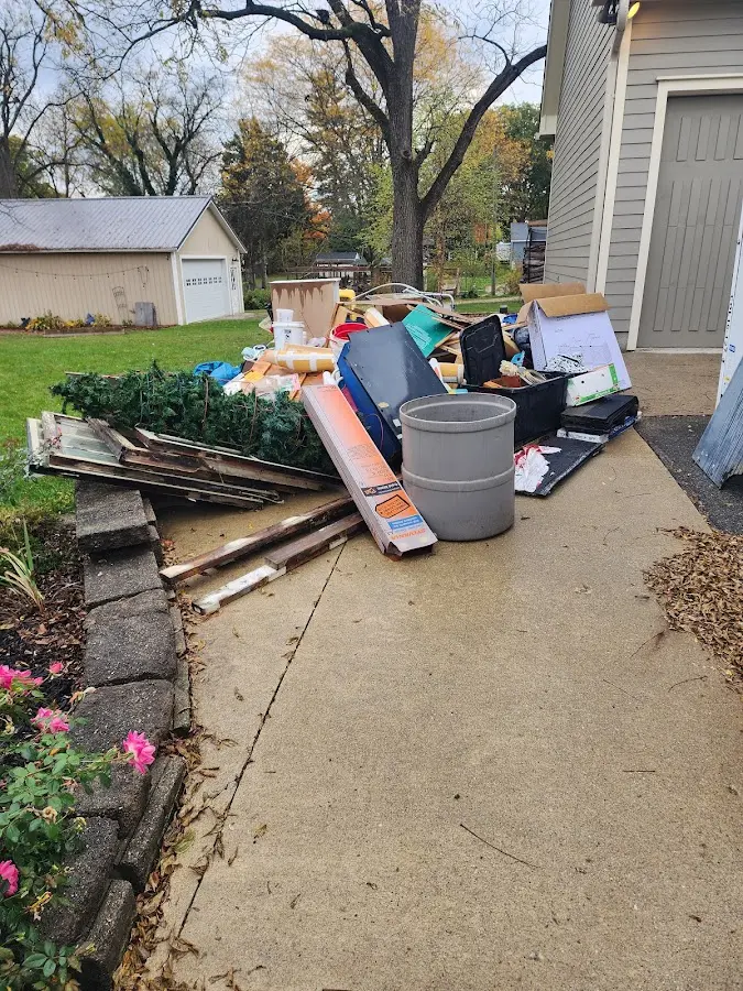 Dumpster being loaded with debris for 12 Yard Dumpster Rental in Everman